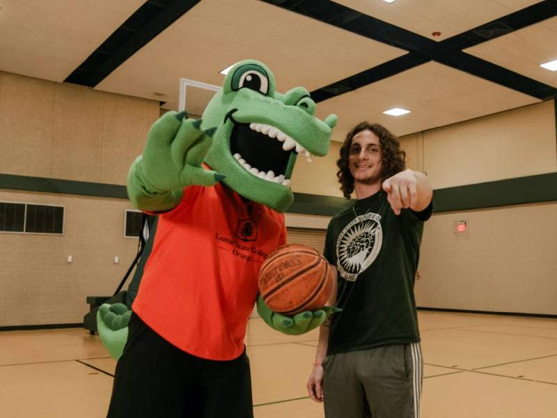 Anthony Barnes and mascot on a basketball court