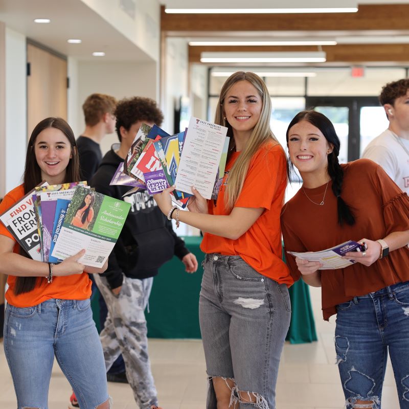 Students showing books
