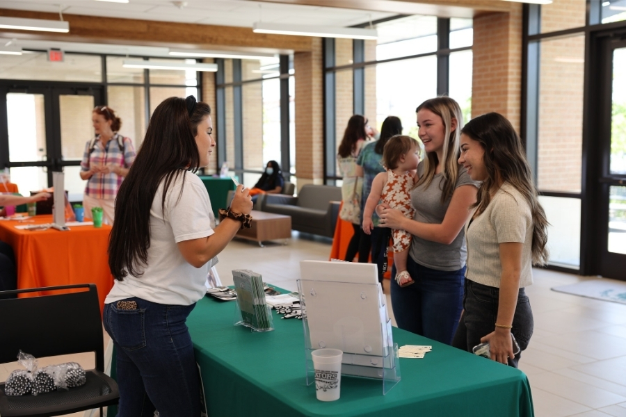 exhibitor helping guests at an event