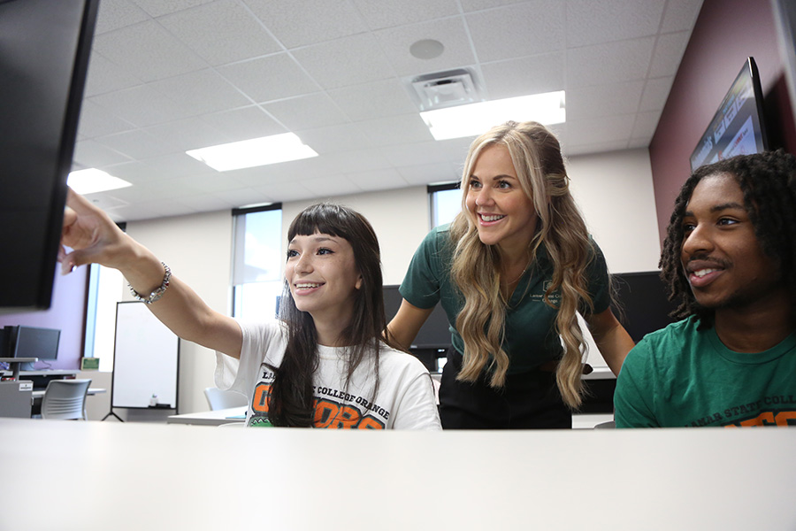 teacher and students engaging over a computer lesson