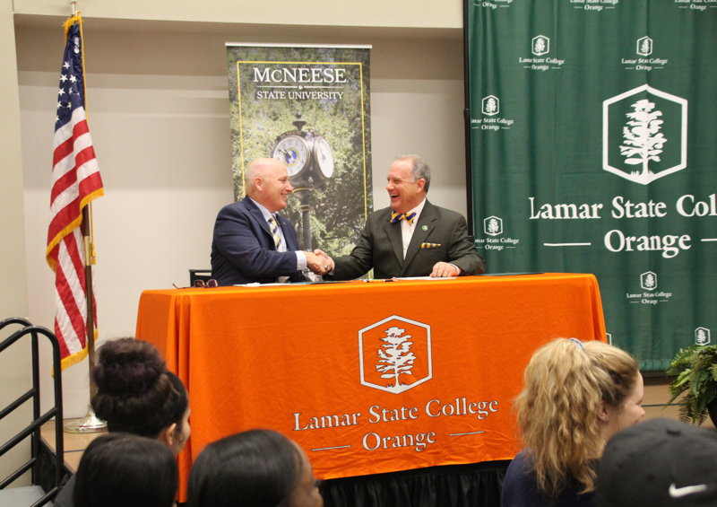 Dr. Johnson and Dr. Burckel shaking hands