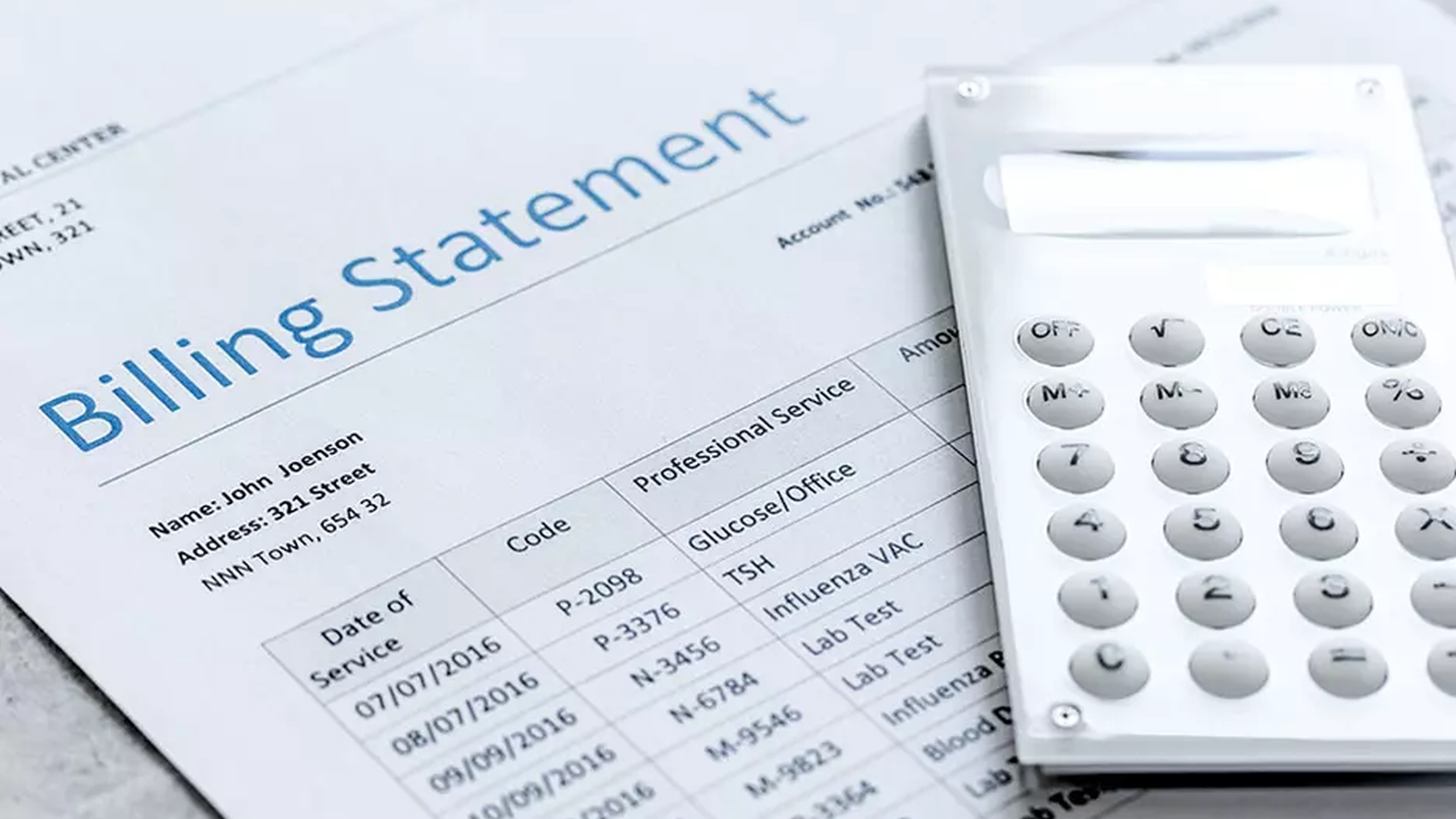 Printed billing statement and calculator on a table top