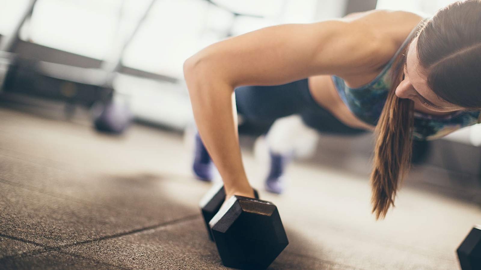 Person completes a work out using weights on the floor